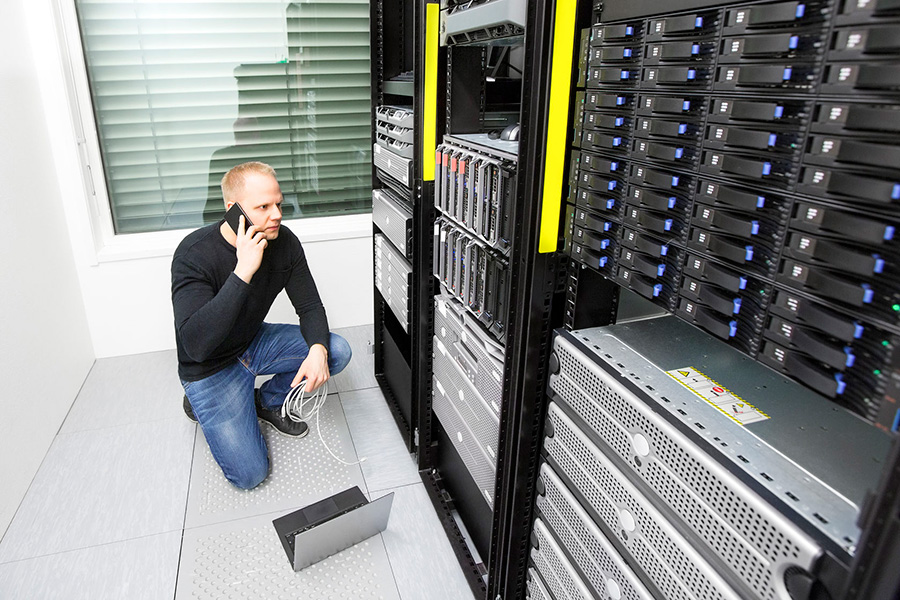 Man on the phone with managed IT services working out a server error. This is a situation many small- to medium-sized businesses (SMBs) may face.